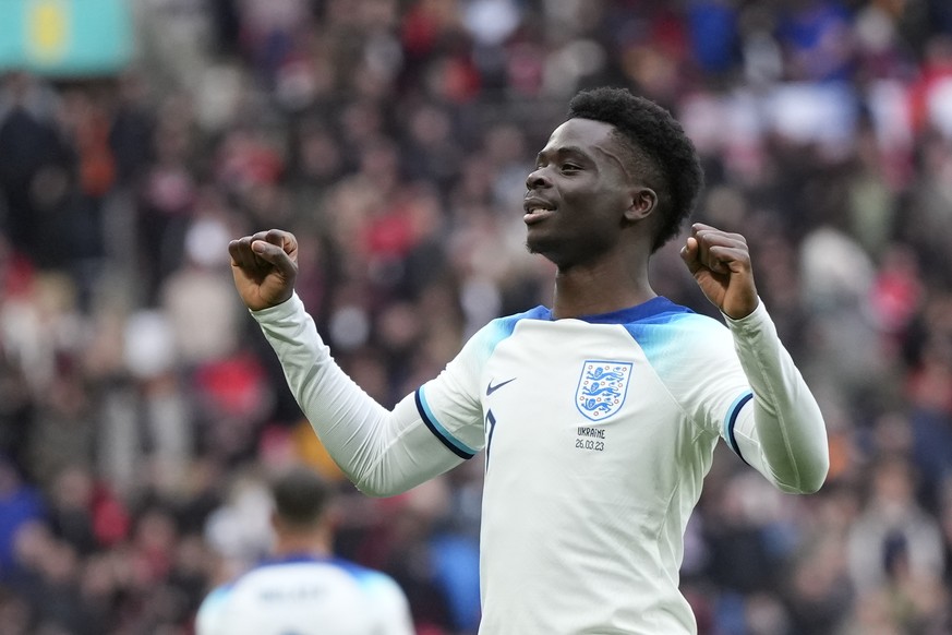 Englands&#039; Bukayo Saka celebrates after scoring his side&#039;s second goal during the Euro 2024 group C qualifying soccer match between England and Ukraine at Wembley Stadium in London, Sunday, M ...