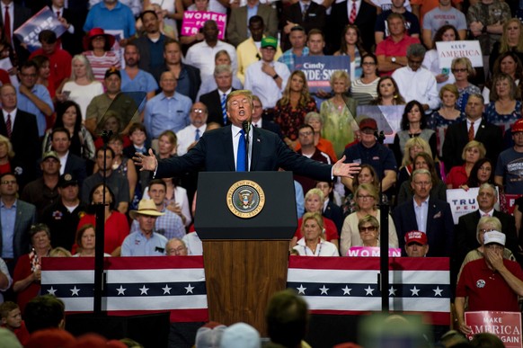 epa07065402 US President Donald J. Trump (C) addresses supporters at a Make America Great Again rally at the Landers Center in Southaven, Mississippi, USA, 02 October 2018. President Trump has been ho ...