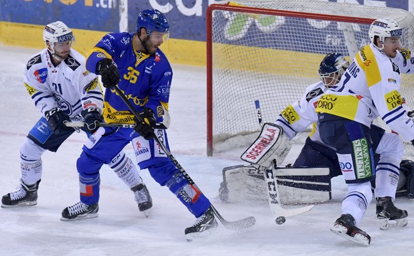 Der Davoser Ahren Spylo (CAN/DE) lauert auf die Scheibe vor Ambris Jason Fuchs und Goalie Sandro Zurkirchen, Spylo (frueher mit Namen Ahren Nittel) spielt nach zehn Jahren Unterbruch heute erstmals wi ...