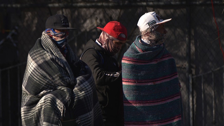 epaselect epa10375032 Migrants wait along the Rio Grande River after US law enforcement erected a riverside barricade to prevent migrants from illegally entering the United States from Mexico…