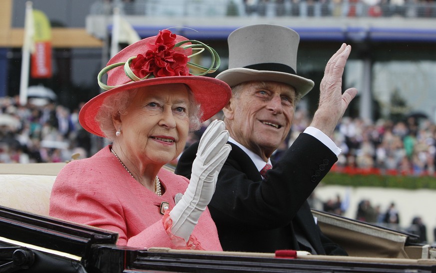 FILE - In this Thursday, June, 16, 2011 file photo Britain&#039;s Queen Elizabeth II with Prince Philip arrive by horse drawn carriage in the parade ring on the third day, traditionally known as Ladie ...