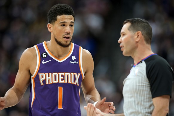Phoenix Suns guard Devin Booker, left, argues after being called for a foul by referee Brian Forte in the first half of Game 5 of the NBA's Western Conference semifinal series against the...