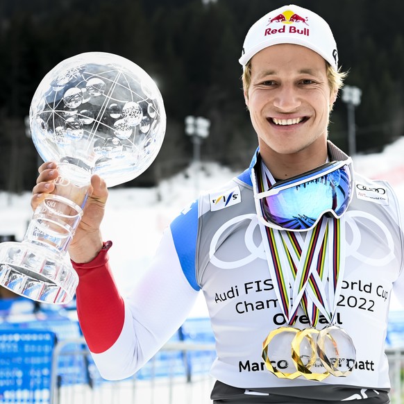 Marco Odermatt of Switzerland poses with the men's overall crystal globe trophy and the men's Giant-Slalom overall leader crystal globe trophy after the podium ceremony at the FIS Alpine Ski ...