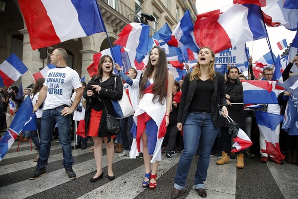 France’s far-right National Front demonstrators chant slogans during their annual May Day march, in Paris, France, Friday, May 1, 2015. France’s far-right National Front is holding its annual May Day  ...