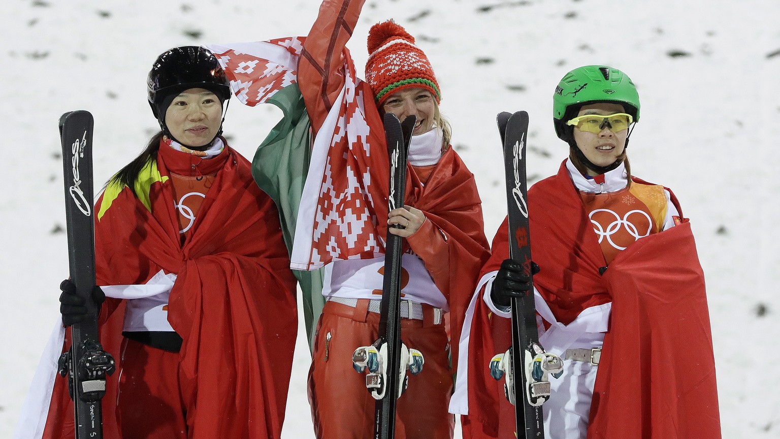 Form left; silver medal winner Zhang Xin, of China, gold medal winner Hanna Huskova, of Belarus, and bronze medal winner Kong Fanyu, of China, celebrate after the women's freestyle aerial final a ...