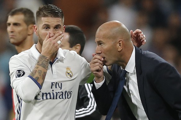 Real Madrid&#039;s head coach Zinedine Zidane gives tactical advise to Real Madrid&#039;s Sergio Ramos during a Champions League, Group F soccer match between Real Madrid and Sporting, at the Santiago ...