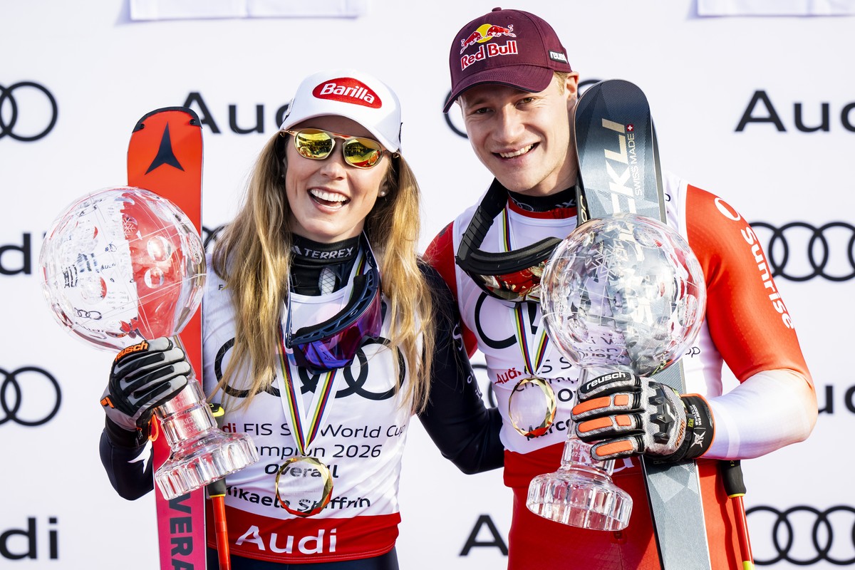 Mikaela Shiffrin of the United States winner of the women's overall crystal globe trophy and Marco Odermatt of Switzerland winner of the men's overall crystal globe trophy celebrate during t ...