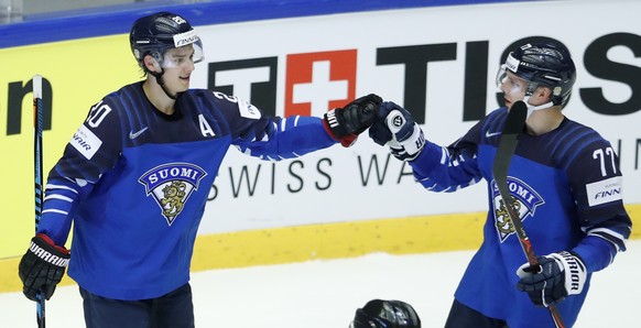Finland&#039;s Sebastian Aho, left, celebrates with Markus Nutivaara, right, after scoring his sides second goal during the Ice Hockey World Championships group B match between Finland and the United  ...