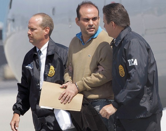 FILE - In this May 13, 2008 file photo, Colombian paramilitary warlord Salvatore Mancuso is escorted by U.S. DEA agents upon his arrival to Opa-locka, Florida. A legal battle is quietly brewing in the ...