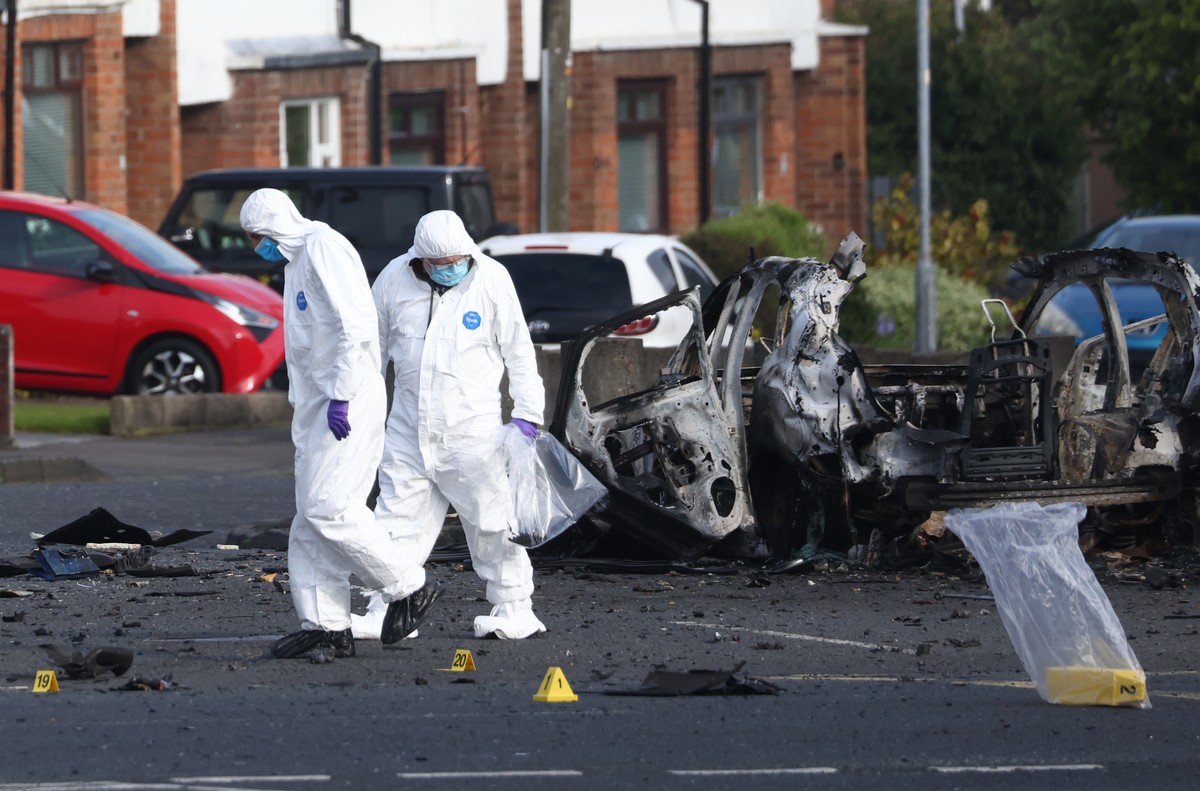 Forensic investigators inspect the site of a car bomb that exploded outside Dunmurry police station in South Belfast, Sunday, April 26, 2026. (AP Photo/Peter Morrison)
Britain Northern Ireland Car Bom ...