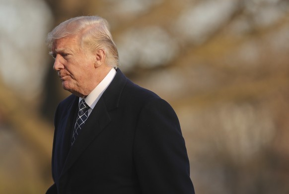 U.S. President Donald Trump walks across the South Lawn of the White House in Washington, Sunday, March 25, 2018, after returning from his Mar-a-Lago estate in Palm Beach, Fla. (AP Photo/Pablo Martine ...