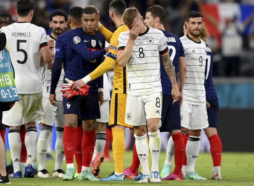 Germany&#039;s Toni Kroos, centre, reacts after his team lost the Euro 2020 soccer championship group F match between France and Germany at the Allianz Arena stadium in Munich, Tuesday, June 15, 2021. ...