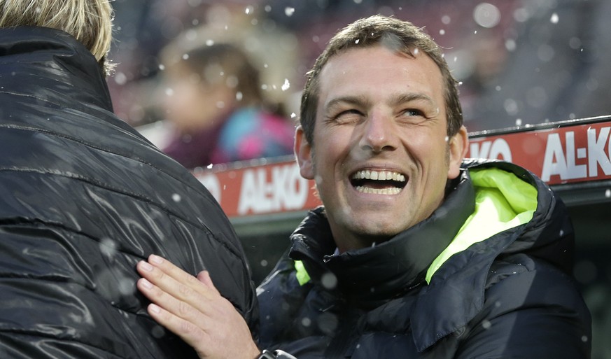Augsburg&#039;s head coach Markus Weinzierl, right, laughs after talking to Hoffenheim&#039;s head coach Markus Gisdol prior to the German first division Bundesliga soccer match between FC Augsburg an ...
