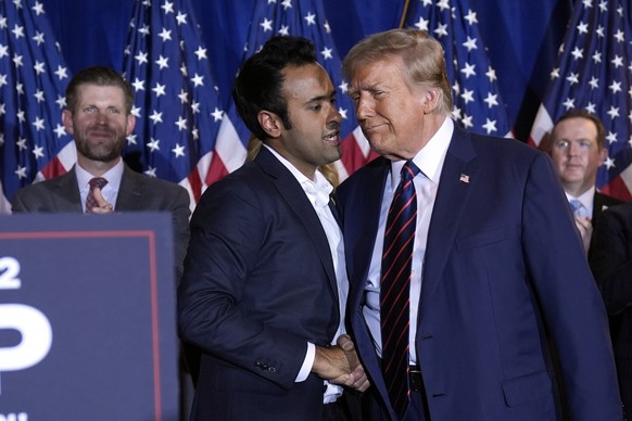 Vivek Ramaswamy shakes hands with Republican presidential candidate former President Donald Trump at a primary election night party in Nashua, N.H., Tuesday, Jan. 23, 2024. (AP Photo/Matt Rourke)