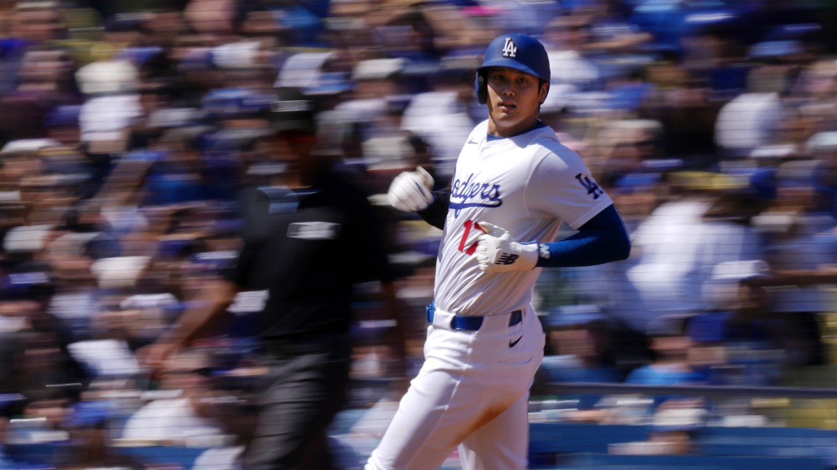 Los Angeles Dodgers' Shohei Ohtani heads to third as Freddie Freeman grounds into a double play to end the third inning of a baseball game against the Colorado Rockies, Sunday, Sept. 22, 2024, in ...