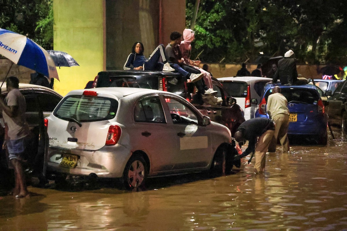 People climb on top of their cars after heavy rains flooded roads in Nairobi, Kenya, on Friday, March 6, 2026. (AP Photo/Andrew Kasuku)
Kenya Floods