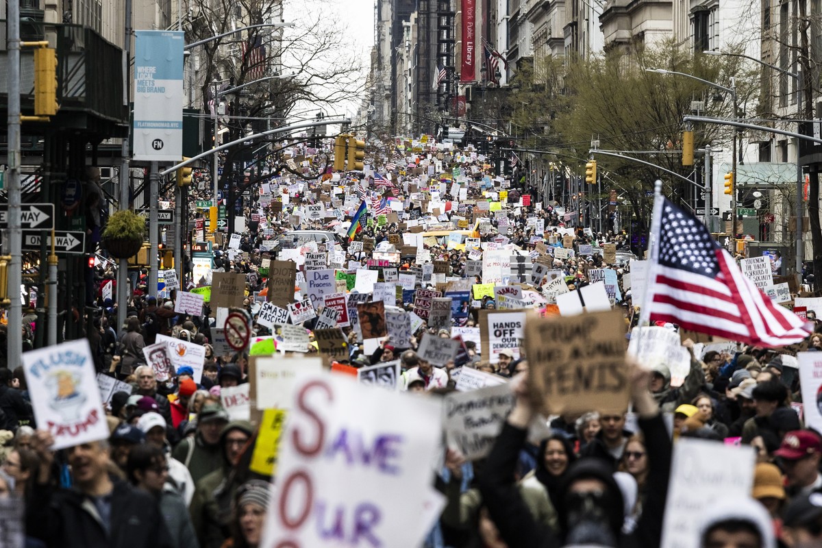 epa12012442 People march down Fifth Avenue during a protest against US President Donald Trump and his administration's policies, in New York, New York, USA, 05 April 2025. Several protests are sc ...