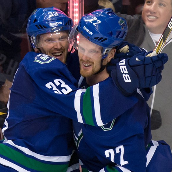 Vancouver Canucks&#039; Daniel Sedin, right, celebrates with his twin brother Henrik Sedin, both of Sweden, after scoring the winning goal against the Montreal Canadiens during overtime of an NHL hock ...