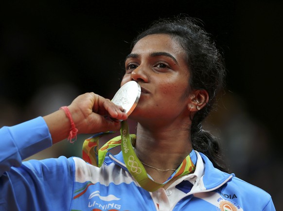 2016 Rio Olympics - Badminton - Women&#039;s Singles - Victory Ceremony - Riocentro - Pavilion 4 - Rio de Janeiro, Brazil - 19/08/2016. Silver medallist P.V. Sindhu (IND) of India poses kissing her me ...