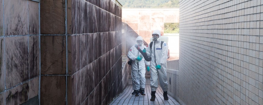 epa08227199 A handout photo made available by Taiwan Ministry of Defense shows Taiwanese military from the 33rd Chemical Group 6th Army Corps personnel sanitizing the Wuhan evacuees quarantine facilit ...