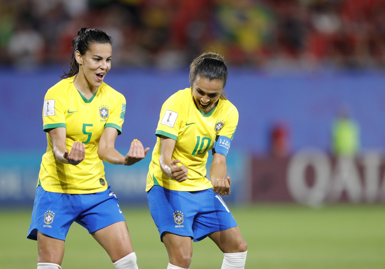 Brazil&#039;s Marta, right, celebrates with Brazil&#039;s Thaisa after scoring her side&#039;s first goal during the Women&#039;s World Cup Group C soccer match between Italy and Brazil at the Stade d ...