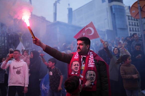 Supporters of President Recep Tayyip Erdogan cheer outside the headquarters of AK Party in Istanbul, Turkey, Sunday, May 14, 2023. More than 64 million people, including 3.4 million overseas voters, w ...