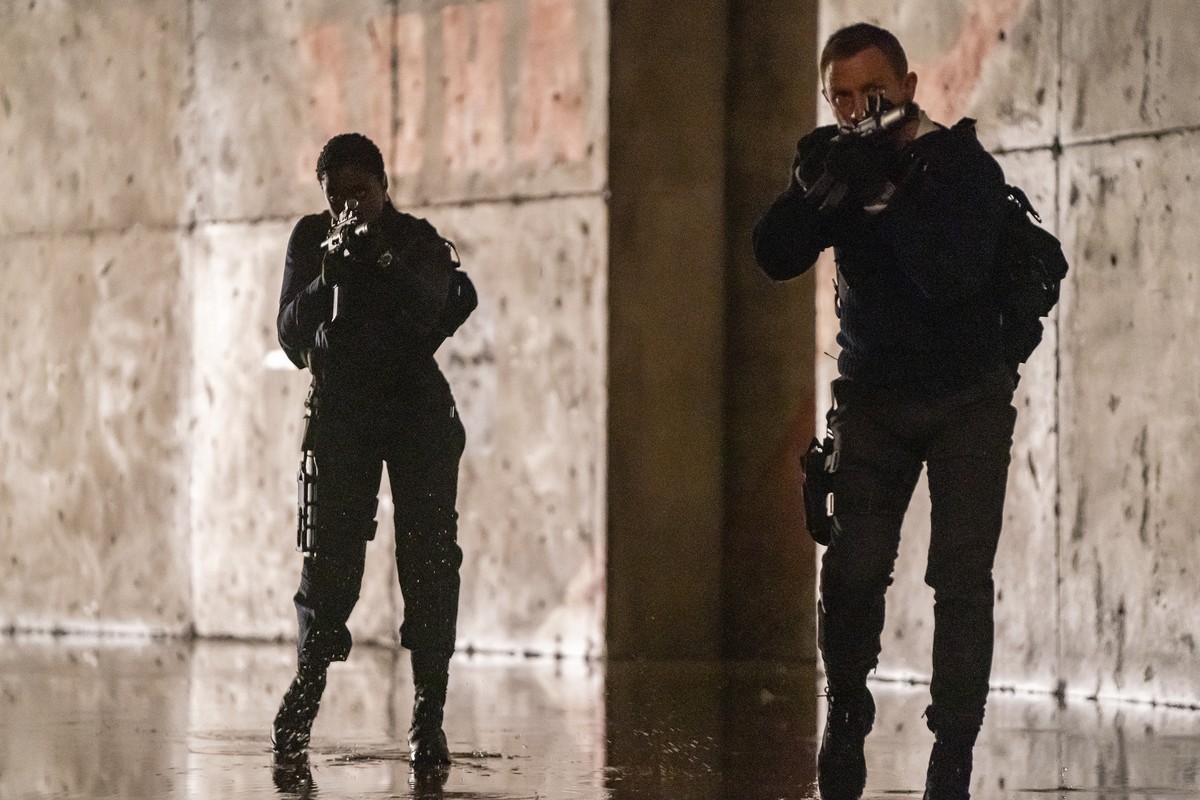 This image released by Metro Goldwyn Mayer Pictures shows Lashana Lynch, left, and Daniel Craig in a scene from "No Time To Die." (Nicola Dove/Metro Goldwyn Mayer Pictures via AP)