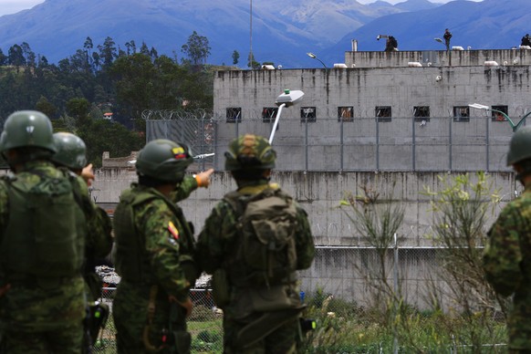 epa09868229 Police officers guard the Liberty Prison No. 1 in Cuenca, Ecuador, 03 April 2022. The National Service for Comprehensive Attention to Adult Persons Deprived of Liberty and Adolescent Offen ...