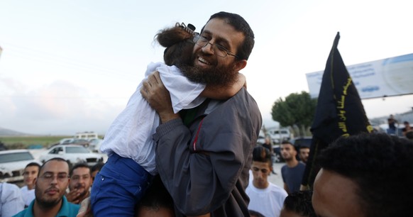 epa10603740 (FILE) - Palestinian Islamic Jihad member Khader Adnan hugs his daughter as he arrives home in the village of Araba, near the West Bank City of Jenin, 12 July 2015 (reissued 02 May 2023).  ...