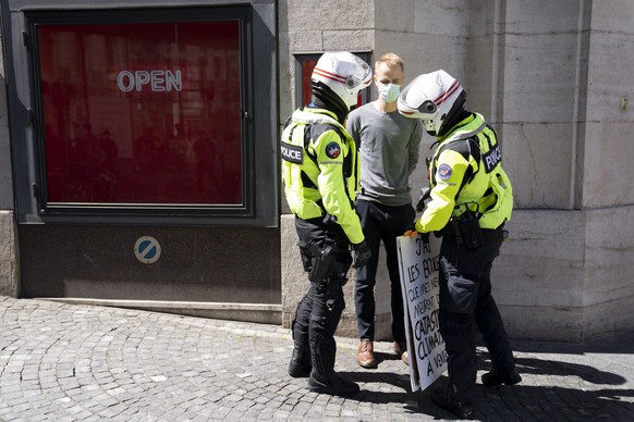 Lausanne police officers arrest a climate activist of Extinction Rebellion (XR) as he sit down with a sign &quot;I&#039;m scared my nephews will die from the coming climate catastrophe&quot; (in frenc ...