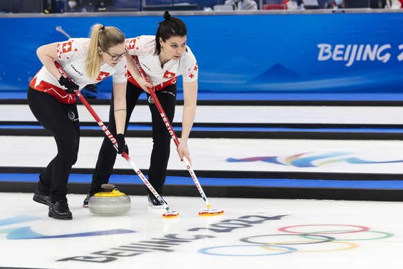 Switzerland's Alina Paetz, left, and Esther Neuenschwander, right, sweep during the Curling semifinal game of the women's between Japan and Switzerland at the National Aquatics Centre at the 2022 Olympic Winter Games in Beijing, China, on Friday, February 18, 2022. (KEYSTONE/Salvatore Di Nolfi)