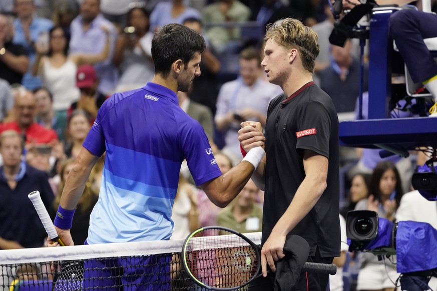 Novak Djokovic, of Serbia, left, greets Jenson Brooksby, of the United States, after beating Brooksby during the fourth round of the U.S. Open tennis championships, Monday, Sept. 6, 2021, in New York. ...