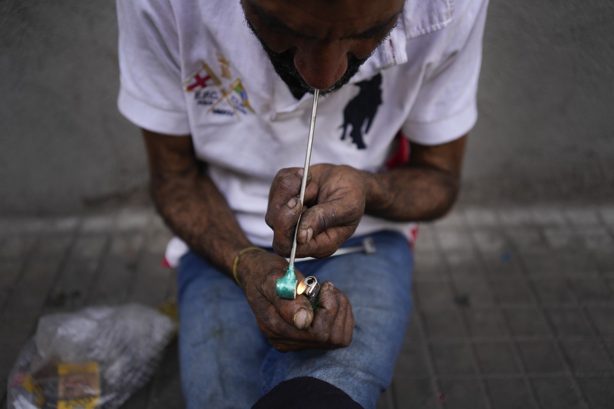 A man smokes crack in "Cracolandia" or Crackland, in downtown Sao Paulo, Brazil, Thursday, Oct. 27, 2022. "Cracolandia" is a popular denomination for this area which is notorious f ...