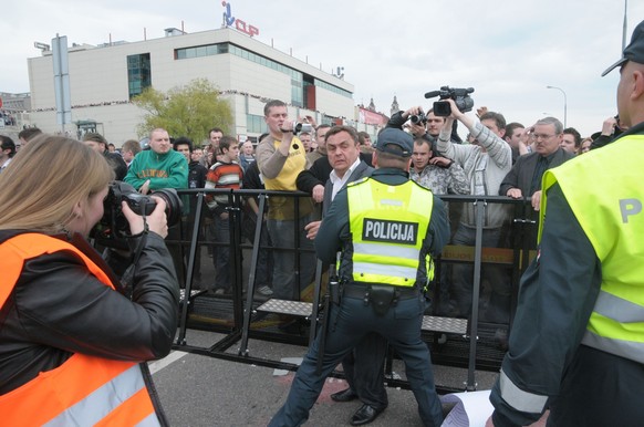 Prostesters of Lithuania gay pride march, A member of parlament of Lithuania Petras Grazhulis fighting with the police officer during the first gay pride parade of Lithuania. Petras Grazhulis is known ...
