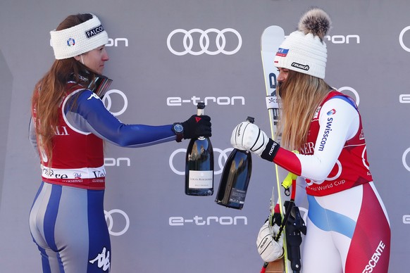 epa08891658 Winner Corinne Suter (R) of Switzerland celebrates on the podium with second placed Sofia Goggia (L) of Italy following the Women&#039;s Downhill race at the FIS Alpine Skiing World Cup ev ...