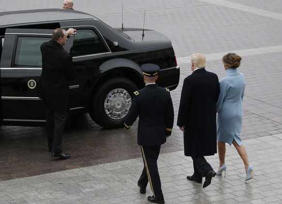 epa05736299 United States President Donald J. Trump (2-R) with First Lady Melania Trump (R) walk to a car at the Capitol Building after the 2017 Presidential Inauguration at the U.S. Capitol in Washin ...