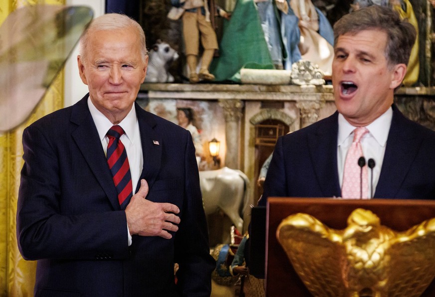 Tim Shriver, Chairman of the Board of the Special Olympics, speaks alongside President Joe Biden at a Christmas for All Dinner in Celebration of Unity, America, and Special Olympics in the East Room o ...