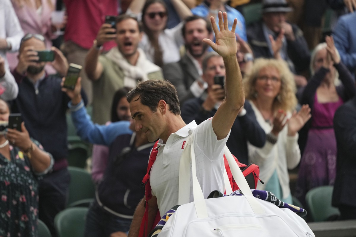 Switzerland's Roger Federer leaves the court after being defeated by Poland's Hubert Hurkacz during the men's singles quarterfinals match on day nine of the Wimbledon Tennis Championshi ...