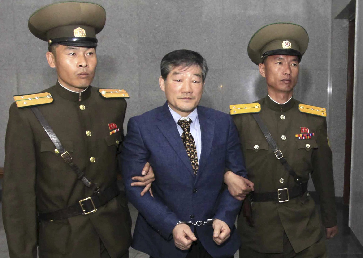 FILE - In this April 29, 2016, file photo, Kim Dong Chul, center, a U.S. citizen detained in North Korea, is escorted to his trialin Pyongyang, North Korea. He was sentenced in April 2016 to 10 years  ...