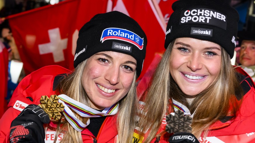 Gold medalist Jasmine Flury of Switzerland, left, and bronze medalist Corinne Suter of Switzerland, right, pose during the medals ceremony of the women&#039;s downhill race at the 2023 FIS Alpine Skii ...