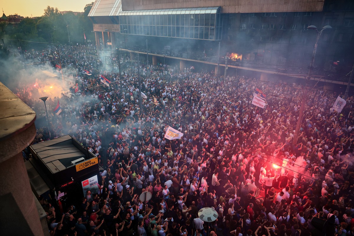 Anti-government protesters light flares as they take part in a rally led by Serbia's protesting university students who are pushing for major political changes in the Balkan country run by Presid ...