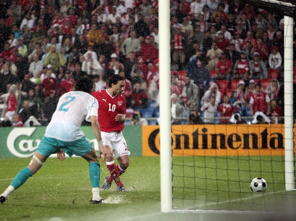 Switzerland&#039;s Hakan Yakin, right, scores the opening goal, watched by Turkey&#039;s Servet Cetin, left, during the second match of Group A between Switzerland and the Republic of Turkey during th ...