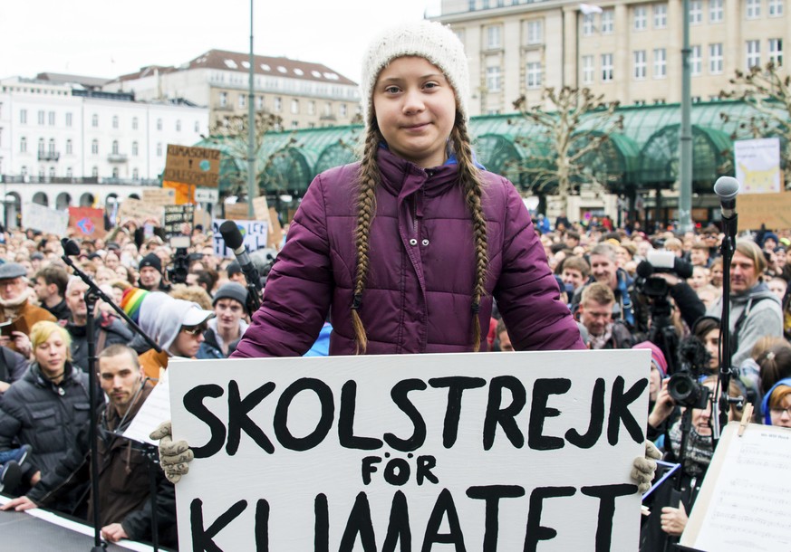 Swedish climate activist Greta Thunberg holds a protest poster as she attends a protest rally in Hamburg, Germany, Friday, March 1, 2019. Slogan reads &#039;School Strike For The Climate&#039;. (Danie ...