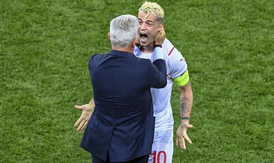 Switzerland&#039;s Granit Xhaka celebrates with manager Vladimir Petkovic after defeating France in a penalty shoot out during the Euro 2020 soccer championship round of 16 match between France and Sw ...