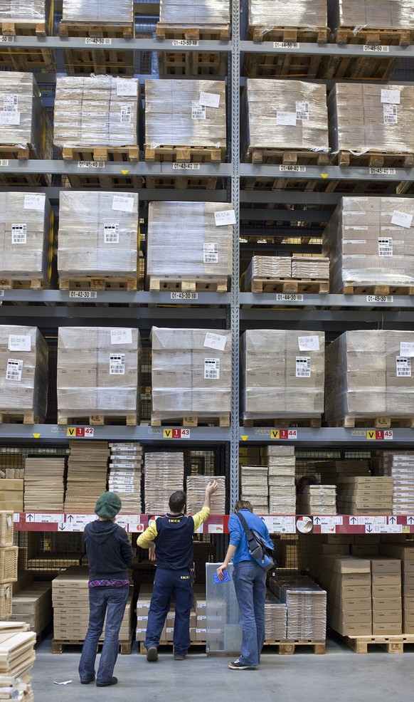 An IKEA employee assists two customers in getting the desired articles at the self-service store of home products retailer IKEA in Spreitenbach in the canton of Aargau, Switzerland, pictured on Octobe ...