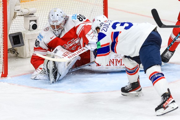 epa11339898 Mats Zuccarello of Norway (R) in action against goalkeeper Frederik Dichow of Denmark (L) during the preliminary round group A match between Denmark and Norway at the IIHF Ice Hockey World ...