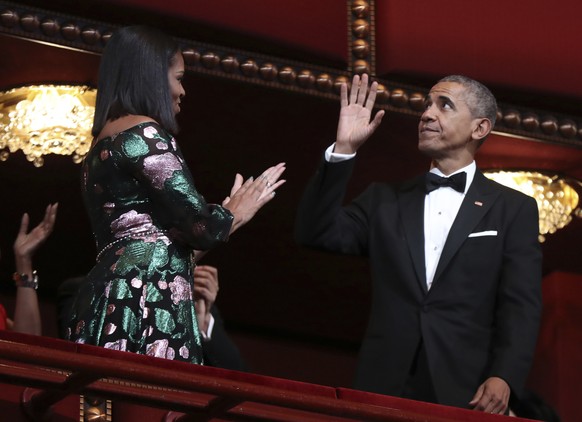 President Barack Obama and first lady Michelle Obama, wave and applaud during the Kennedy Center Honors gala at the Kennedy Center in Washington, Sunday, Dec. 4, 2016. (AP Photo/Manuel Balce Ceneta)