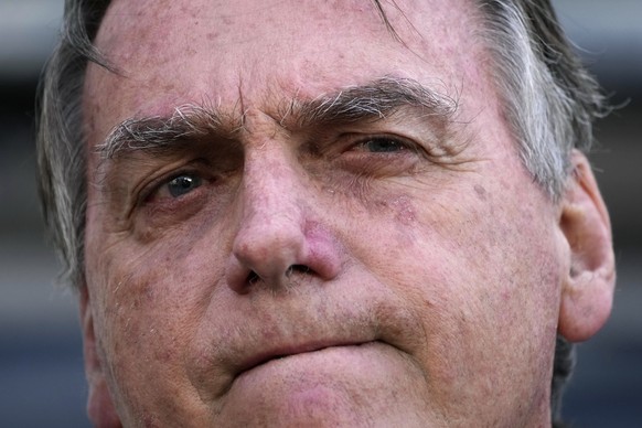 FILE - Brazil&#039;s former President Jair Bolsonaro speaks to the press as he leaves the Federal Police headquarters where he gave testimony about his actions related to the Jan. 8 attacks on governm ...