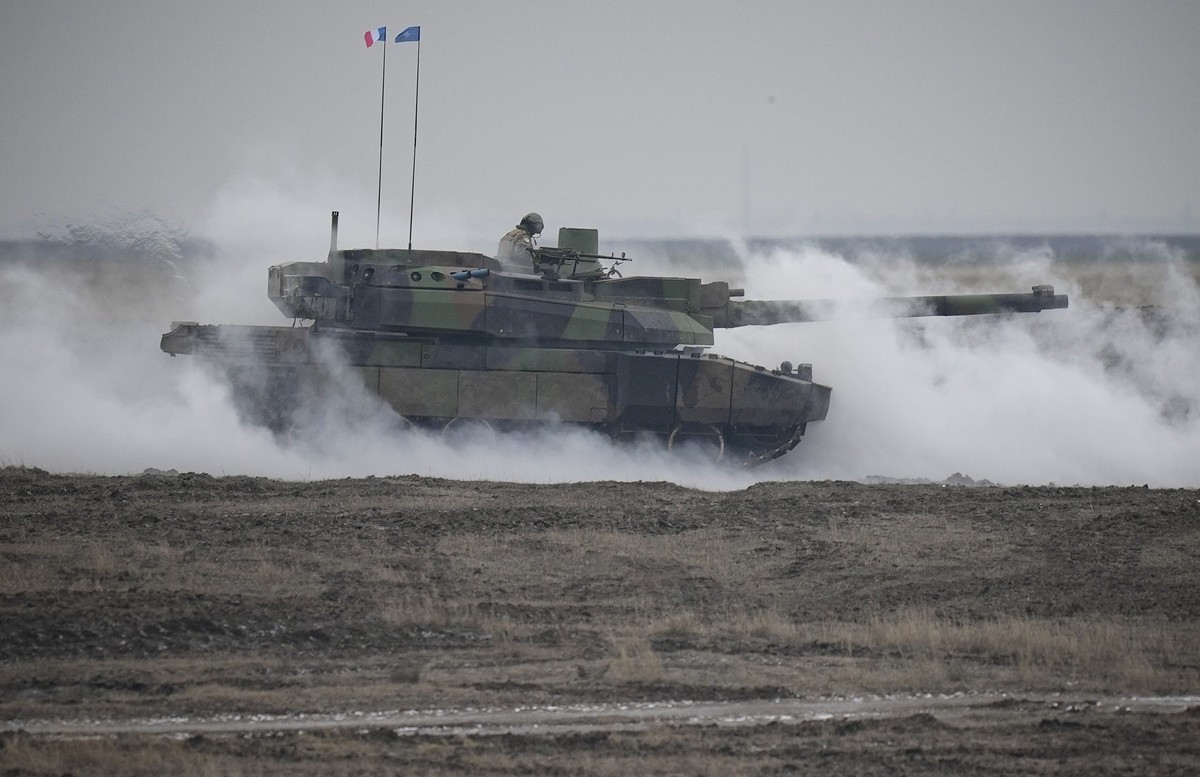 A French Leclerc main battle tank is engulfed by smoke during an exercise at a training range in Smardan, eastern Romania, Wednesday, Jan. 25, 2023. Around 600 French soldiers deployed to Romania as p ...
