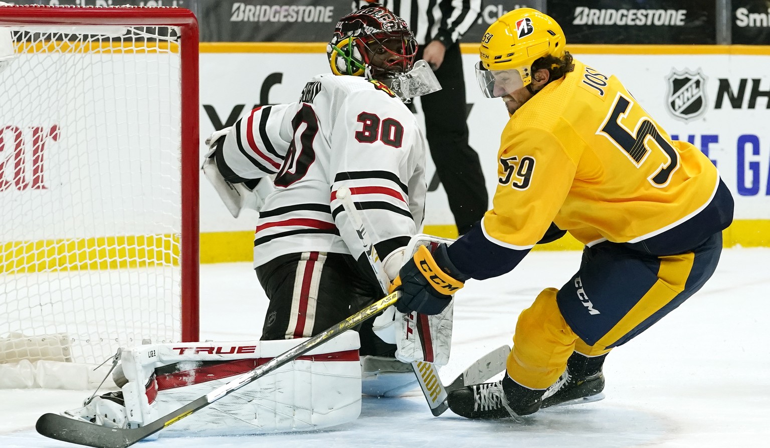 Nashville Predators defenseman Roman Josi (59) scores the winning goal against Chicago Blackhawks goaltender Malcolm Subban (30) in overtime of an NHL hockey game Tuesday, Jan. 26, 2021, in Nashville, ...